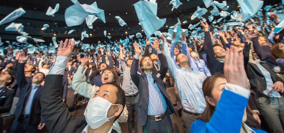 Anniversaries - people throwing blue cloths in the air
