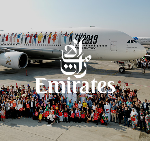 people standing in front of an Emirates aircraft