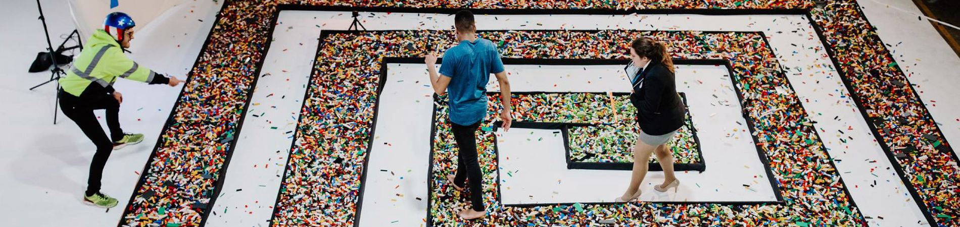 man walking on lego and adjudicator watching over